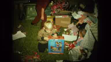 FORT WAYNE INDIANA-1976: Family Opening Christmas Gifts In Living Room