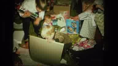 Fort Wayne Indiana (1976): Children Opening Christmas Gifts Together Surrounded By