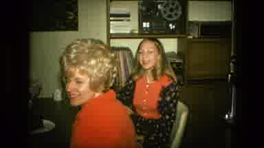 Fort Wayne Indiana (1976): A Woman Smiles In A Silly Way While Sitting At A Table