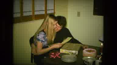 Fort Wayne Indiana (1976): Woman Sitting On A Mans Lap Opening Up Gifts At A Table