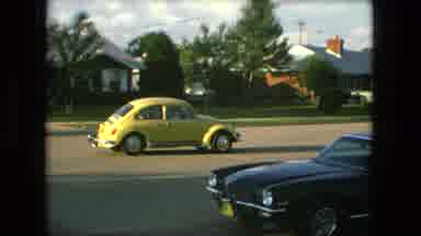 Fort Wayne Indiana (1976): Yellow Volkswagen Beetle Driving Away