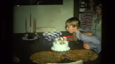 FORT WAYNE INDIANA-1976: Girl Blowing Out Candles On Her Birthday Cake