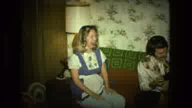 Fort Wayne Indiana (1976): A Laughing Woman Who Is Wearing A Dress Inside A Home