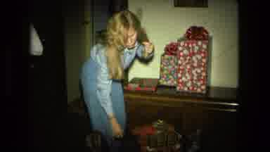 Fort Wayne Indiana (1976): Girl Opens Her Present During Christmas Morning While