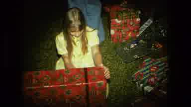 Fort Wayne Indiana (1976): Little Girl Unwrapping Ribbon From Large Christmas Gift