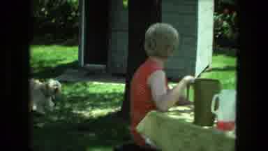 Fort Wayne Indiana (1976): Women Have A Meal Outside Their Home And Watch A Dog