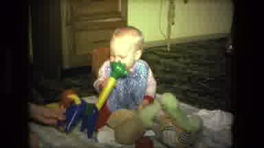 Fort Wayne Indiana (1976): Baby Sits On Blanket And Plays With Colorful Giraffe