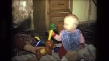 Fort Wayne Indiana (1976): One Children Playing A Toy With Mother Inside The House