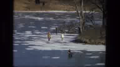 Fort Wayne Indiana (1976): Three People In Coats And Jackets Wading Through