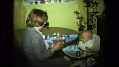 Fort Wayne Indiana (1976): A Lady Is Talking And Feeding A Little Boy