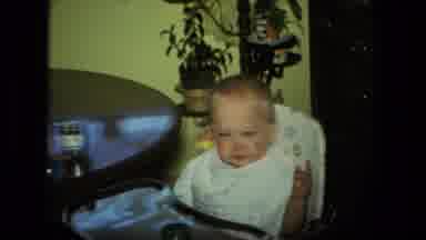 Fort Wayne Indiana-1976: Baby Sitting At Kitchen Table Being Fed By Woman