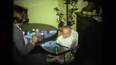 Fort Wayne Indiana (1976): Lady Feeding A Baby In A High Chair Baby Food From A