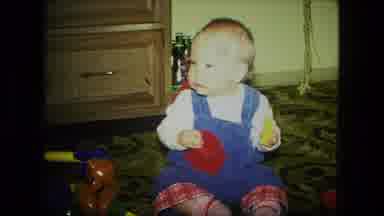 Fort Wayne Indiana (1976): Young Baby Playing And Eating With Red And Yellow Toys