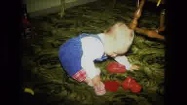 Fort Wayne Indiana (1976): A Little Baby Playing With His Red Toys At Home Then