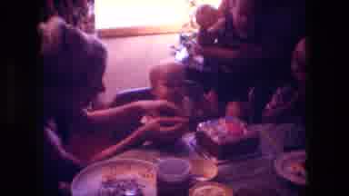 Fort Wayne Indiana (1976): A Women Is Helping A Baby Decorate A Cake By Holding