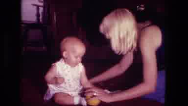 Fort Wayne Indiana (1976): A Blonde Lady And A Baby Sitting Up As She Puts Snacks