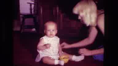 Fort Wayne Indiana (1976): Mother Cleaning Up Food Spilled By Her Baby At Home