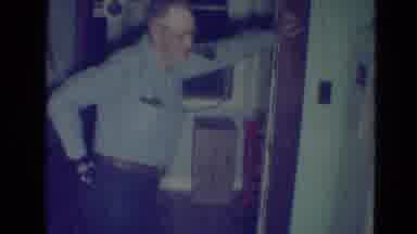 Minnesota (1976): Elderly Man Looks On As Child Lifts Some Sort Of Fabric Perhaps