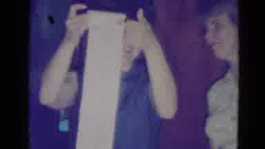 Minnesota (1976): A Lady At A Party Rolling A Paper