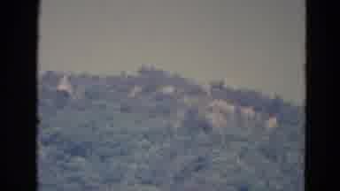 Minnesota (1976): Horizon Broken By Mountainside Covered With Trees Camera Cuts To