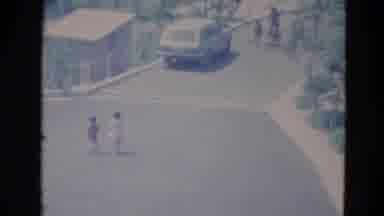 Minnesota (1976): Two Children Holding Hands Running Up A Neighborhood Street