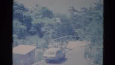 Minnesota (1976): A Very Shaky Shot Of A Car On A Street Surrounded By A Lot Of