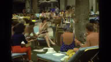 Las Vegas (1978): Woman Standing Surrounded By Others Holds Paper And Brushes Hair