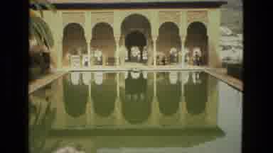 Cordoba Spain (1978): Red Flowers Blooming And People Walking Past Reflection Pool