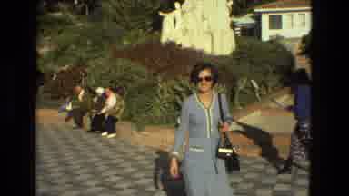 Seville Spain (1978): A Woman Is Walking Down The Park And Some People Are Sitting