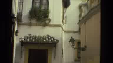 Seville Spain (1978): Beautiful Tall White Building With People Walking Through