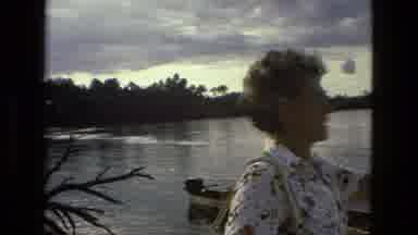 MANAUS BRAZIL-1979: Family On Boat By River With Cloudy Sky