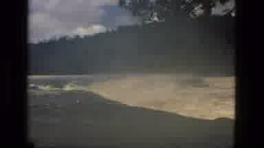 MANAUS BRAZIL-1979: Rushing White River Rapids Surrounded By Tall Trees And Hills