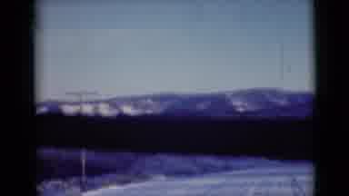Alaska (1946): A Snow Covered Mountain Range From Inside A Car