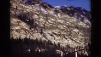 Alaska (1946): A Large Mountain Side During Winter With Snow And Pine Trees