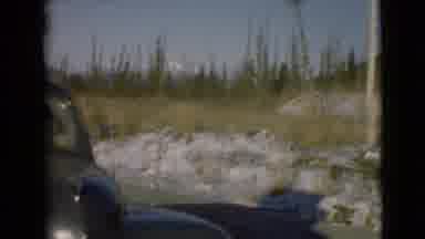 Alaska (1946): A Woman Sits In A Well-Loaded Car While A Man Stands Next To It In