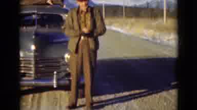 Alaska (1946): Man Putting On A Red Hat While Standing In The Cold In Front Of His