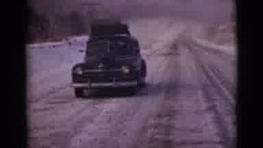 Alaska (1946): Black Car With Luggage On Top On Empty Roads In The Alaskan