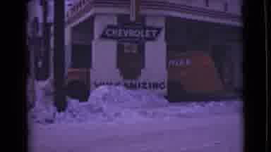 ALASKA-1946: Red Chevrolet Chief Van Parked Outside Snowy Commercial Building