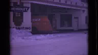 Alaska (1946): Red Car Parked Under Carport On A Clear Winter Day