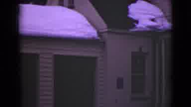 Alaska (1946): Camera Pans Across The Snow Covered Brown Building And Captures It