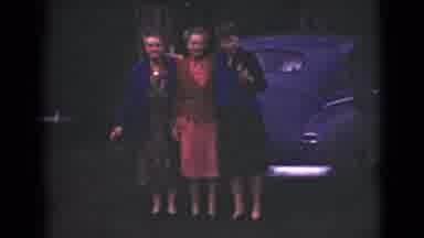 Alaska (1946): Three Elderly Women Standing In Front Of A Blue Car With A Puppy