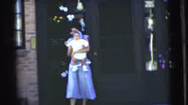 Chatham New Jersey (1951): A Woman Wearing A Blue Dress Coming Out Of A Building