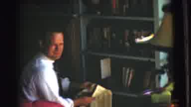 Chatham New Jersey (1951): Man Speaking In Home While Reading Newspaper In Front