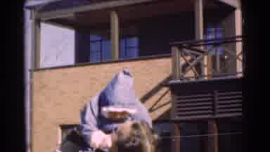 Chatham New Jersey (1951): Man Standing Outside Holding Up Toddler On A Windy Day