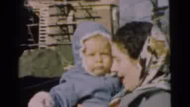 Chatham New Jersey (1951): Woman Standing Outside Wearing A Coat Holding A Baby In