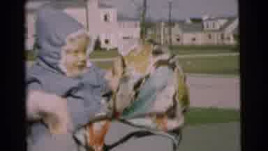 Chatham New Jersey (1951): Woman Playfully Bouncing Small Boy Outside As He
