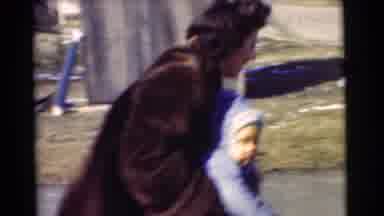CHATHAM NEW JERSEY-1951: Woman In Fur Coat Picking Up Child And Walking