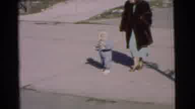 Chatham New Jersey (1951): Toddler In Winter Clothes Shuffles Around As Mother