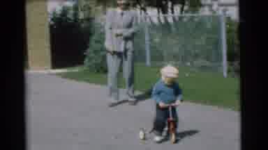 Chatham New Jersey (1951): Man Wearing Grey Suit Watches Child Wearing Blue