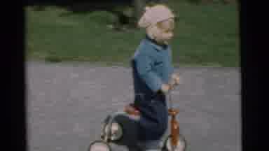 Chatham New Jersey (1951): A Small Child Plays On A Tricycle Bike Outside With